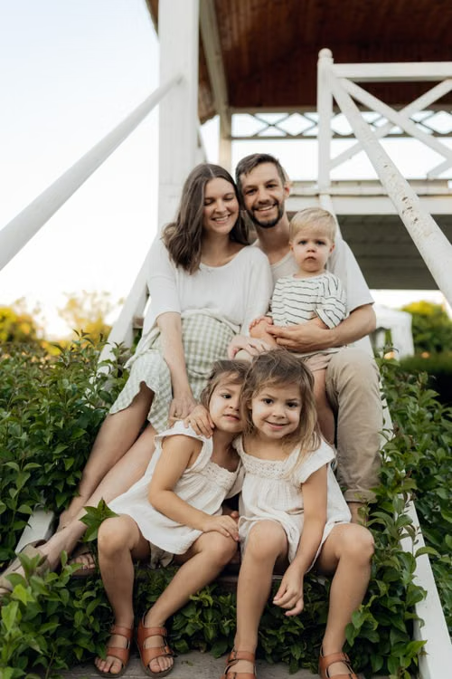 Family sitting together on porch steps