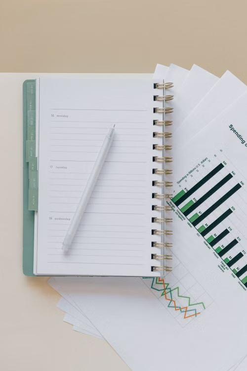 Planner notebook and progress charts on a desk